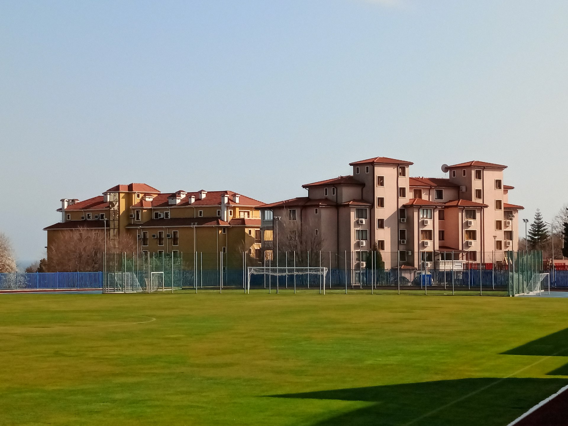a soccer field with a building in the background